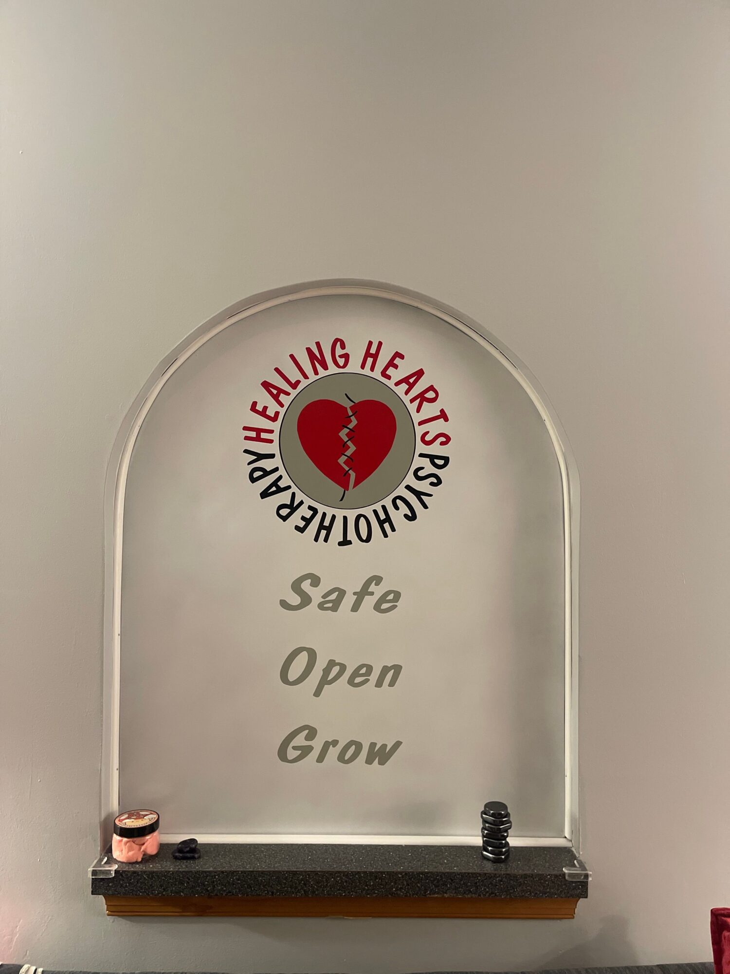 Glass plaque with a heart logo and text: 'Healthy Hearts PS' and words: 'Safe, Open, Grow'.