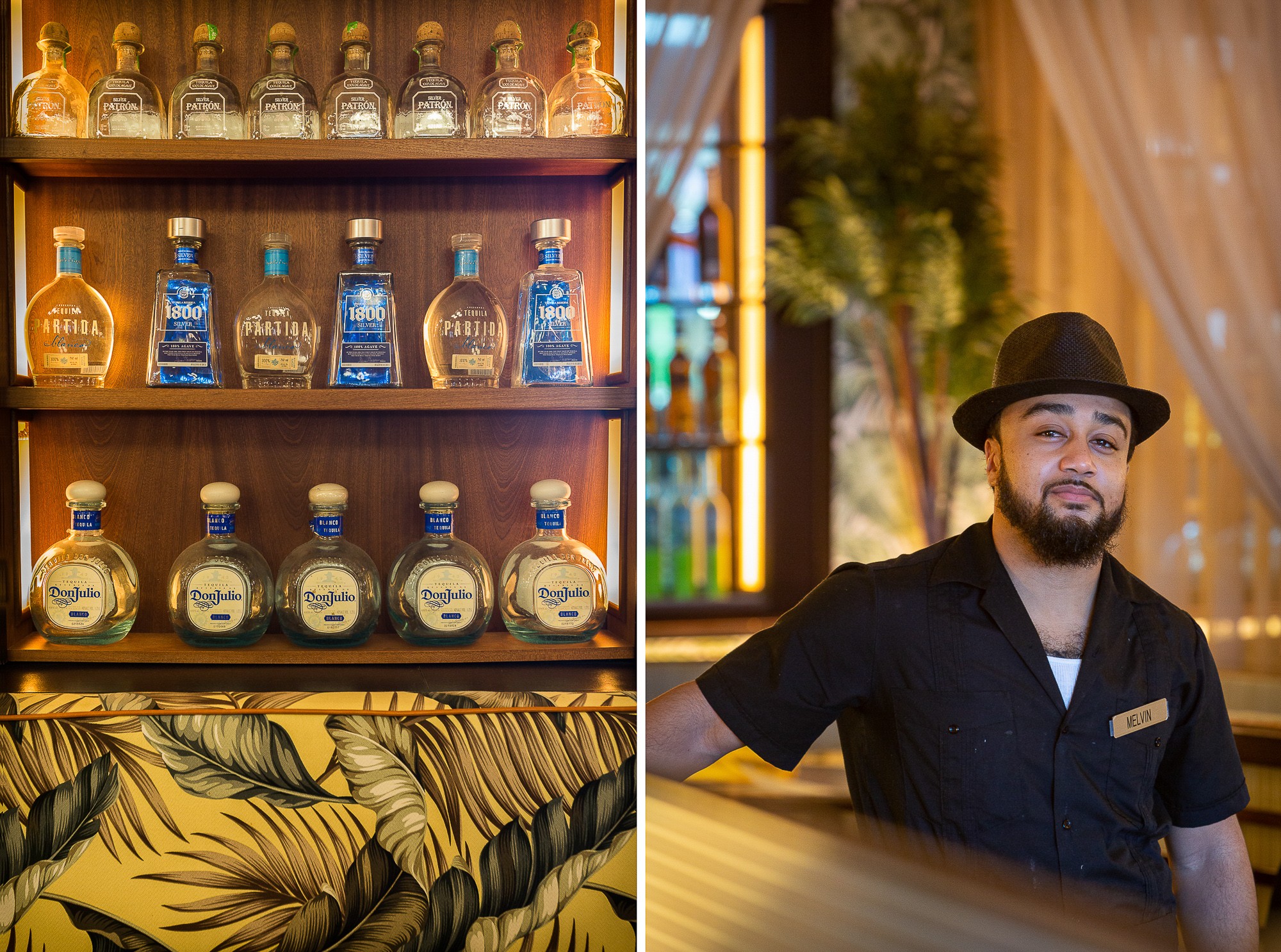 Display of various bottles on shelves and a man wearing a black hat and shirt sitting indoors.