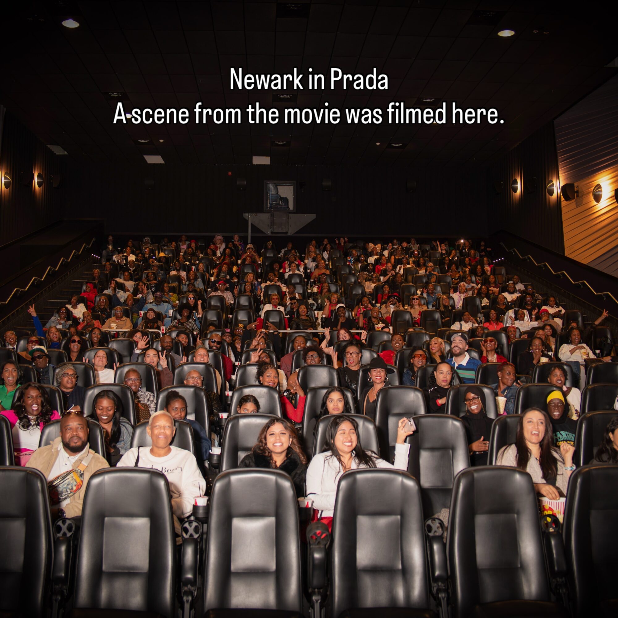 Movie theater with audience watching a film, screen displays text about Newark in Prada, 20 words.