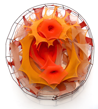 Colorful abstract sculpture with orange, yellow, and red elements inside a wireframe sphere, resembling a fiery or floral design.