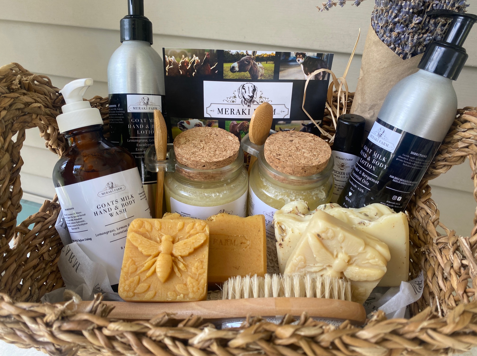 Wicker basket containing soap, bottles, and a magazine, with soap bars and brushes visible inside.