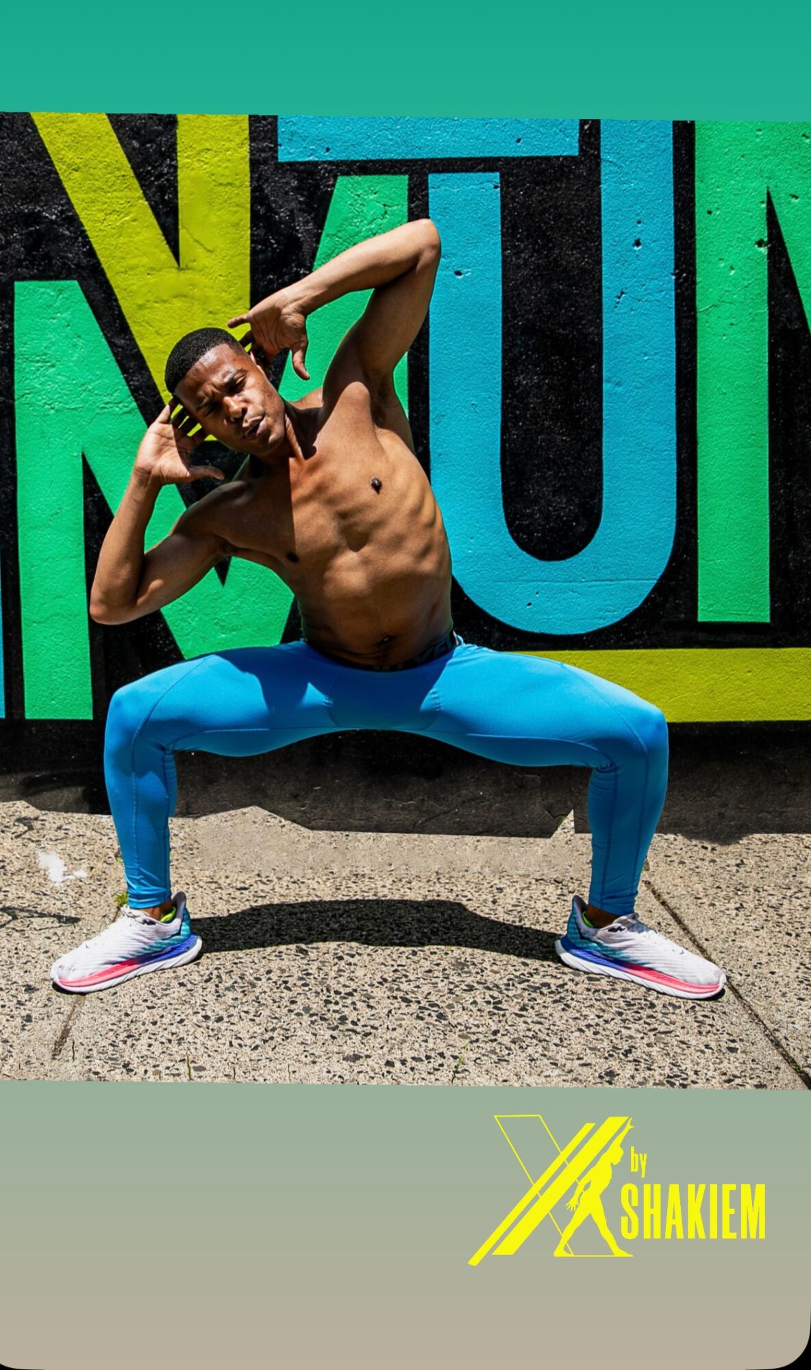 Person posing shirtless in front of a colorful background with large text, wearing blue pants and sneakers.