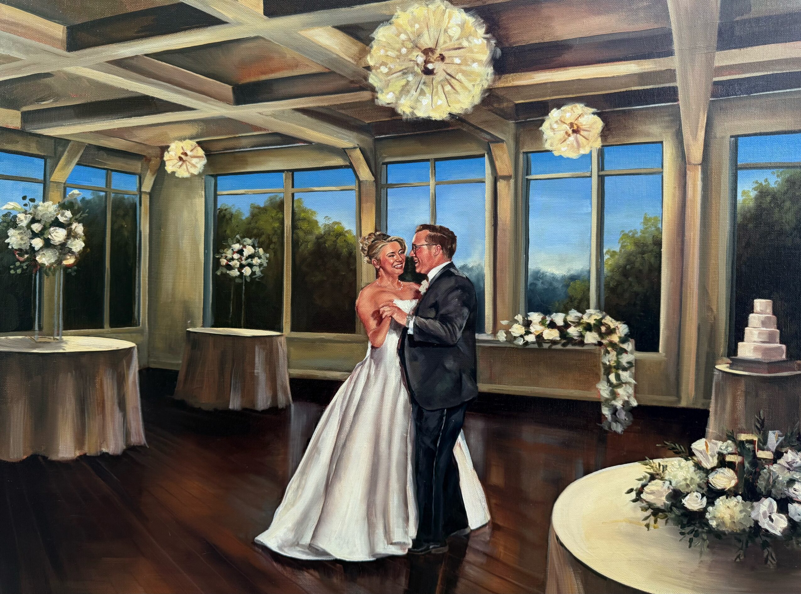Couple dancing in a decorated indoor venue with large windows, floral arrangements, and a wedding cake, during daytime.