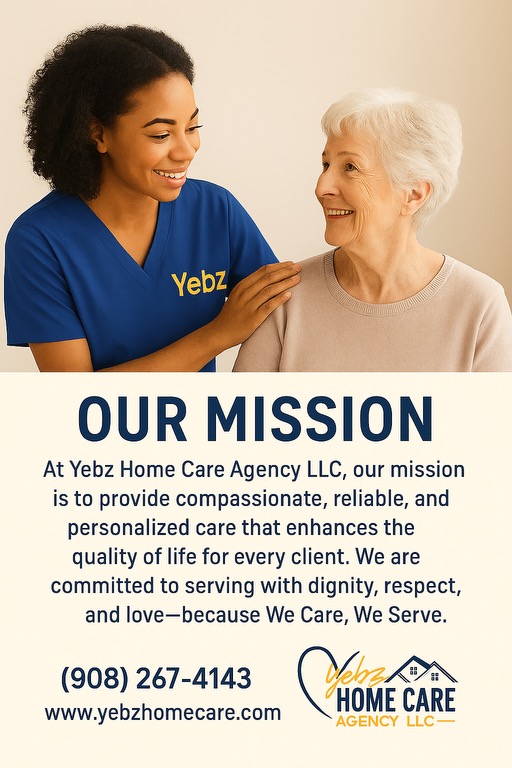 Young caregiver with dark curly hair smiling at elderly woman with white hair, both indoors, warm lighting.