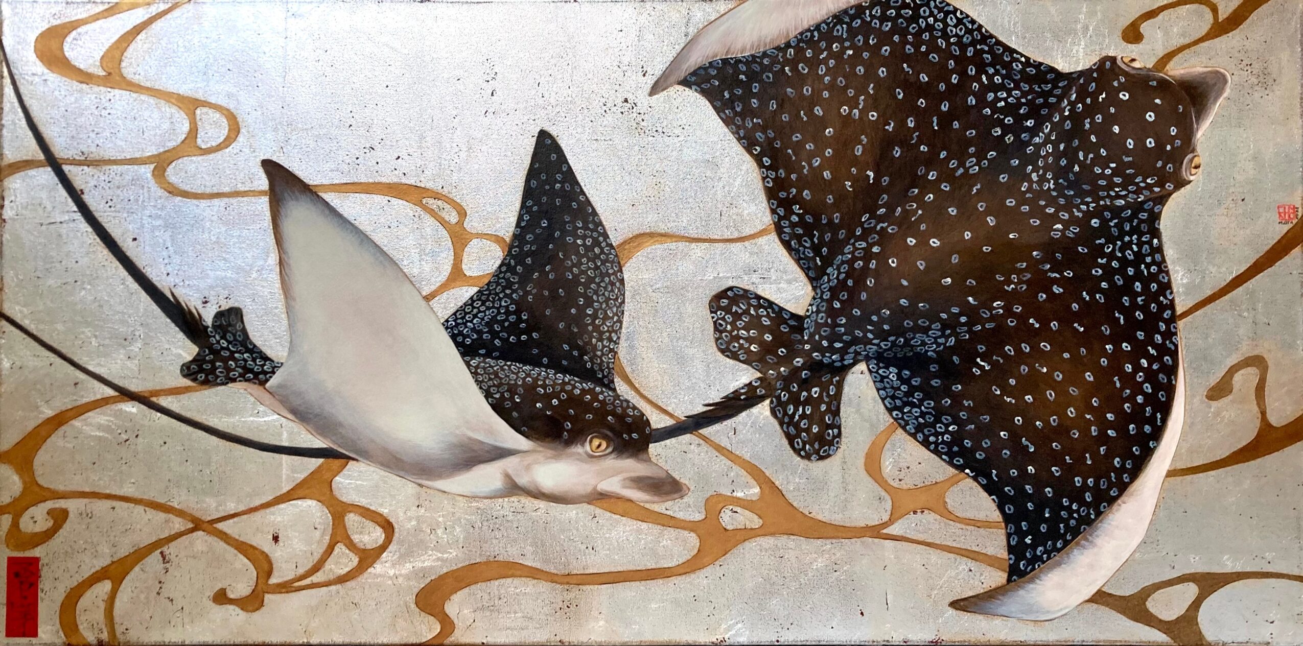 Two manta rays swimming with flowing golden lines in the background, one with white and black spots, the other dark with white spots.