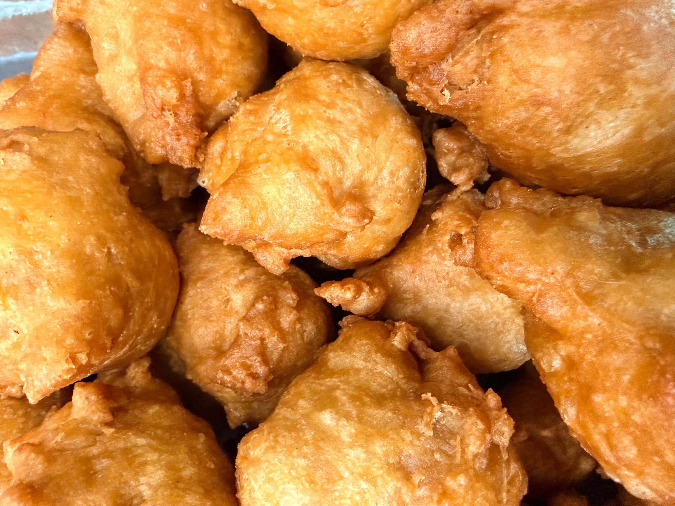 Close-up of golden-brown fried chicken pieces with crispy coating.