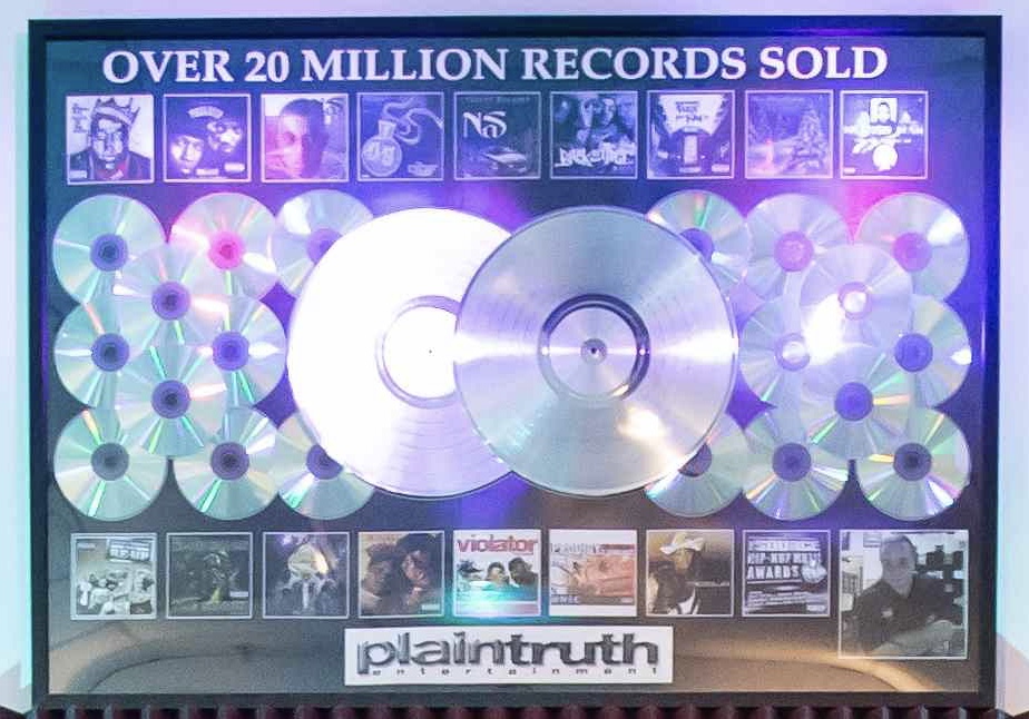 Display with CDs, album covers, and text stating over 20 million records sold, with a logo at the bottom.