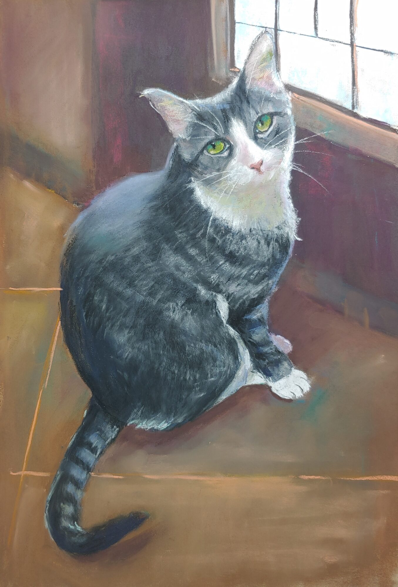 Gray tabby cat with green eyes sitting on a wooden surface near a window, looking up.