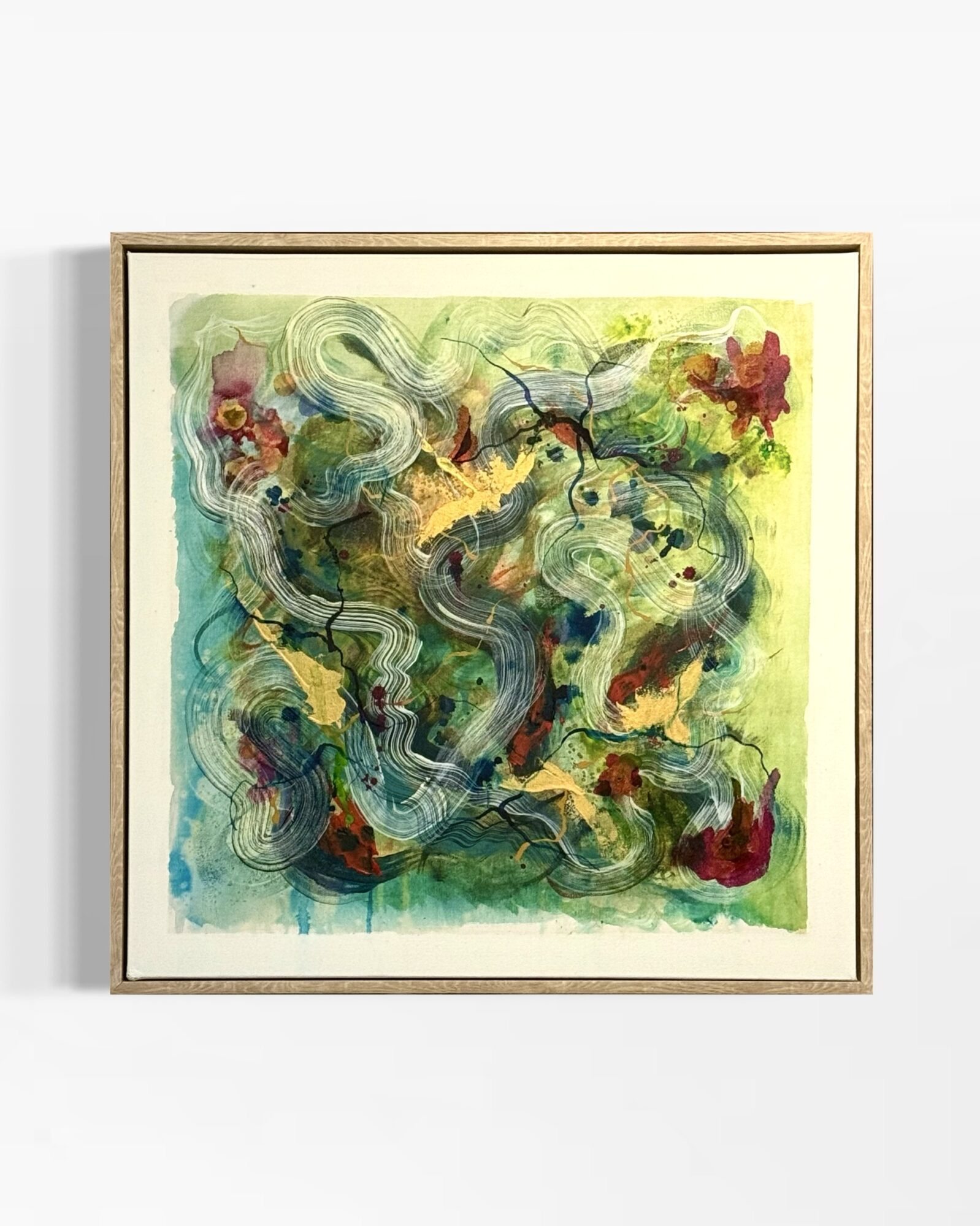 Abstract painting with swirling lines, colorful shapes, and splashes of red, yellow, and green, framed in a light wooden frame.