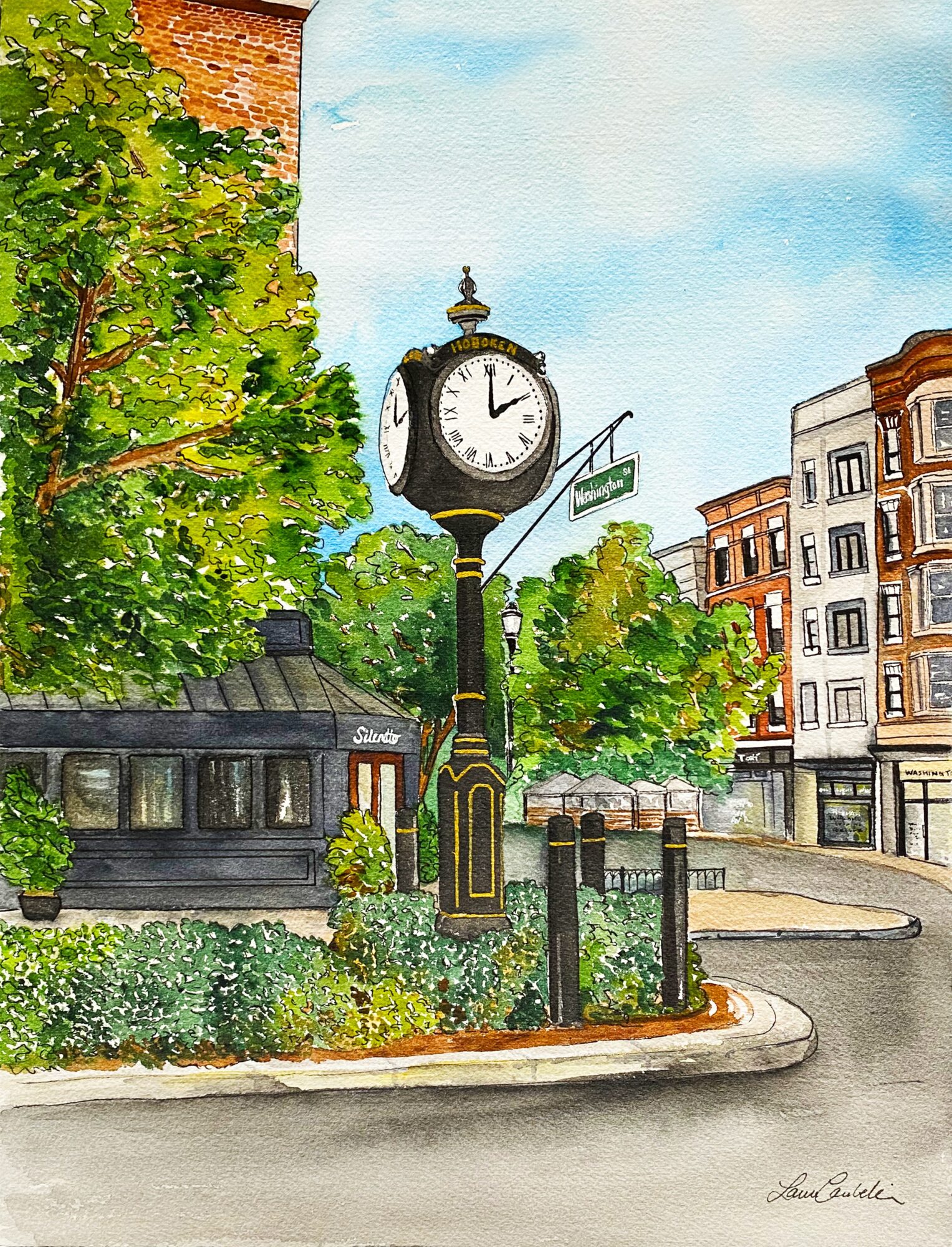 Street clock on a pole, surrounded by trees and buildings, with a blue sky background.