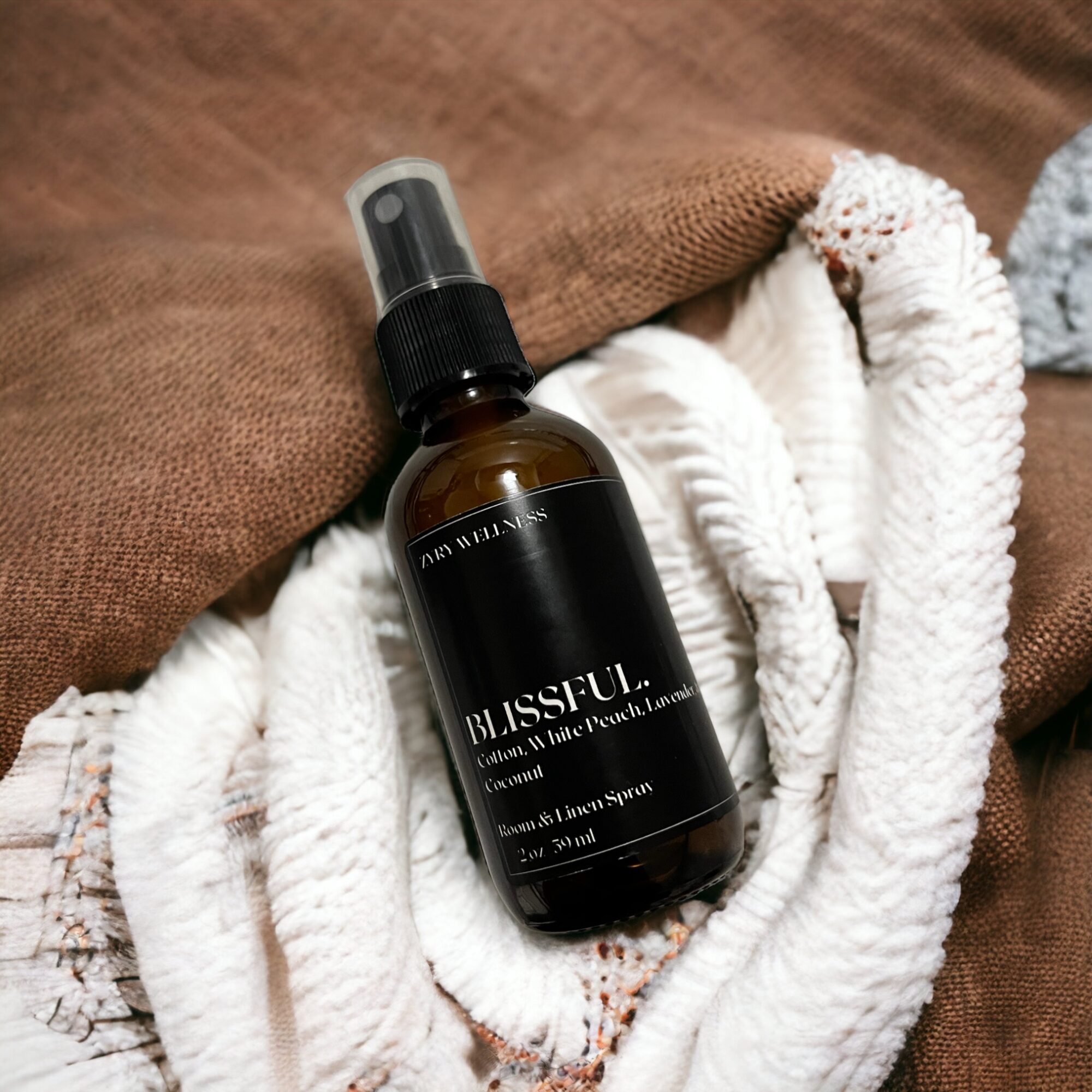 A brown spray bottle labeled 'RESFUL' resting on white fabric with a brown cloth background.