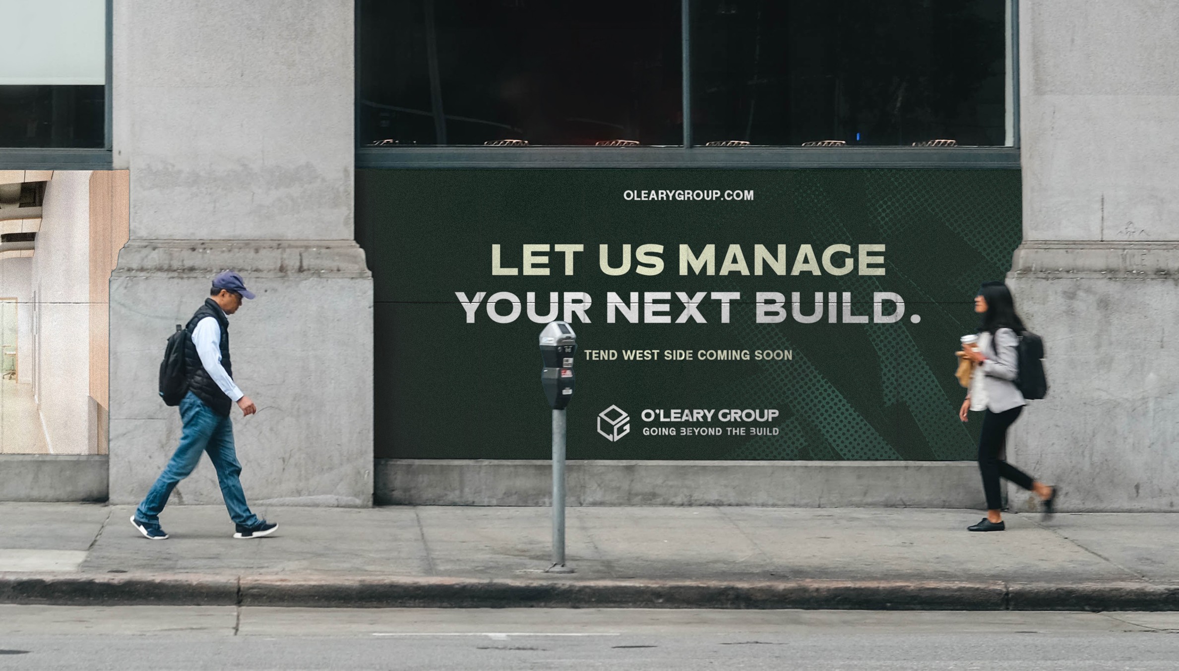 Two people walk past a building with a large green sign that reads,