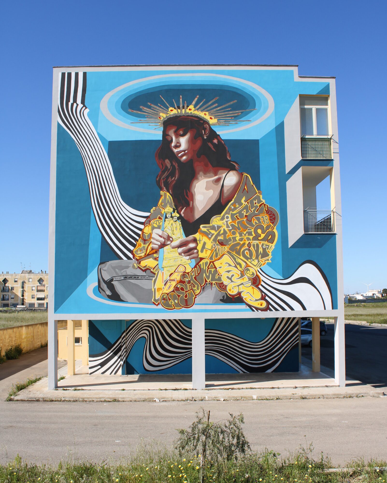 Mural of a seated person holding flowers, surrounded by flowing black-and-white lines on a blue building.