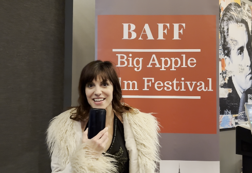 Person standing beside a BAFF Big Apple Film Festival banner.